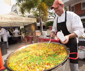 Chef Paul serving his Fire & Rice Paella at the farmers' market